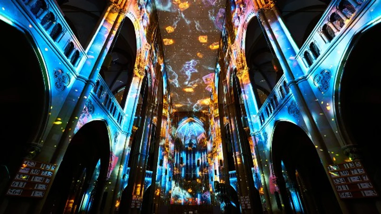 Eonarium immersive projection mapping experience inside a European church with blue and gold projections across vaulted ceilings